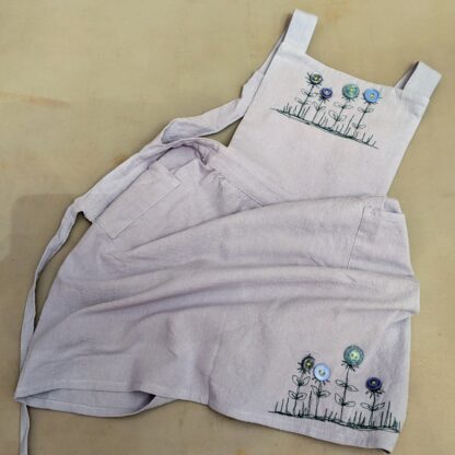 Kids apron with free motion embroidery and buttons